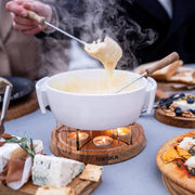 Boska Candle Light Fondue Twinkle, white fondue set serving melted cheese at the table