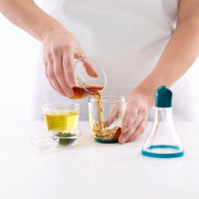 Filling the Lékué blue dressing shaker