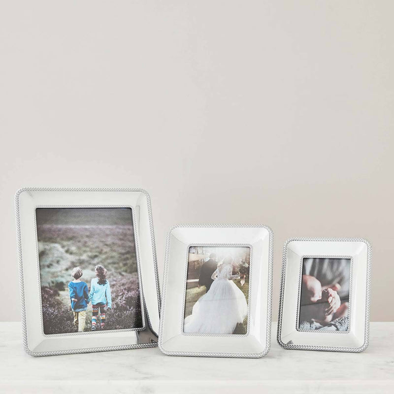 Nambé Braid Photo Frame in a display setting; other items shown are sold separately.