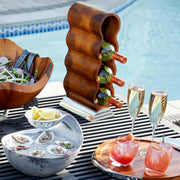 Nambé Curvo Wine Rack in a display setting; other items shown are sold separately.