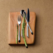 Nambé Frond 5-Piece Place Setting in a display setting; other items shown are sold separately.