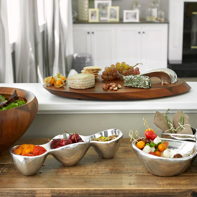 Nambé Swoop Cheese Board with Knife in a display setting; other items shown are sold separately.